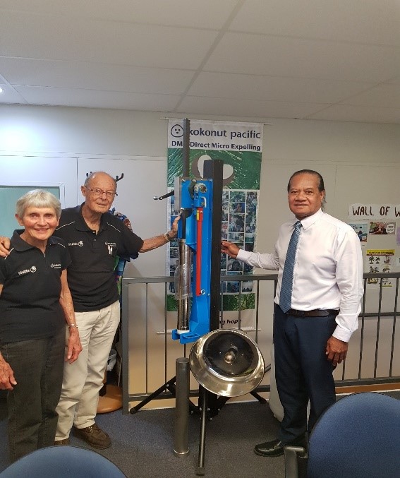 Dr. Etherington and wife Maureen showing Mr. Sisilo the DME/coconut crushing machine he invented.