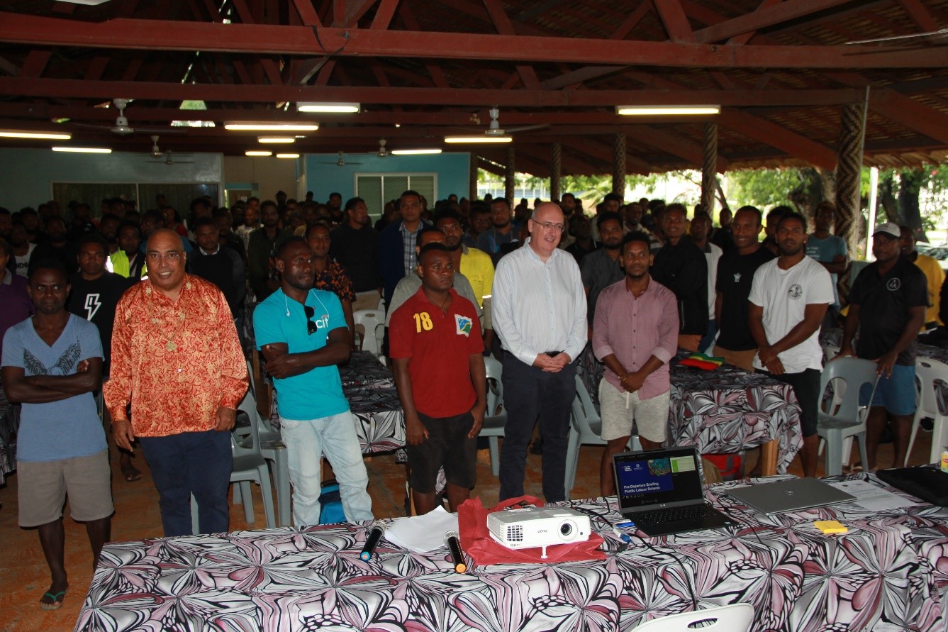 PS Collin Beck and HE Dr Lachlan Strahan in a photo shoot with the workers at the Pre-Departure Briefing, St. Barnabas Leafhut. 