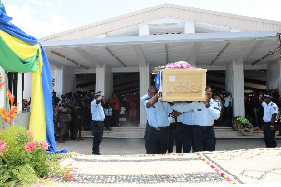 Police officers carrying the casket of the late Ambassador Fugui after his funeral today