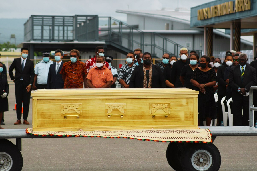 The casket of the late Ambassador lies in front of family and government officials after being flown into the country from China on Tuesday