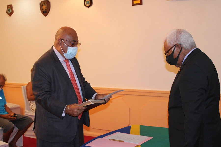 Re-appointed Permanent Secretary of the Ministry of Foreign Affairs and External Trade, Colin Beck reading his oath of allegiance before Governor General, Sir David Vunagi at Government House today (21/11/22).