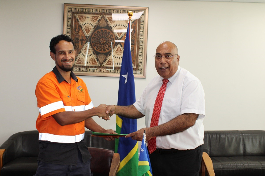 General Manager of SkyEye, Solomon Chant shakes hand with the Permanent Secretary of the Ministry of Foreign Affairs and External Trade, Colin Beck after the renewal of their contract yesterday.