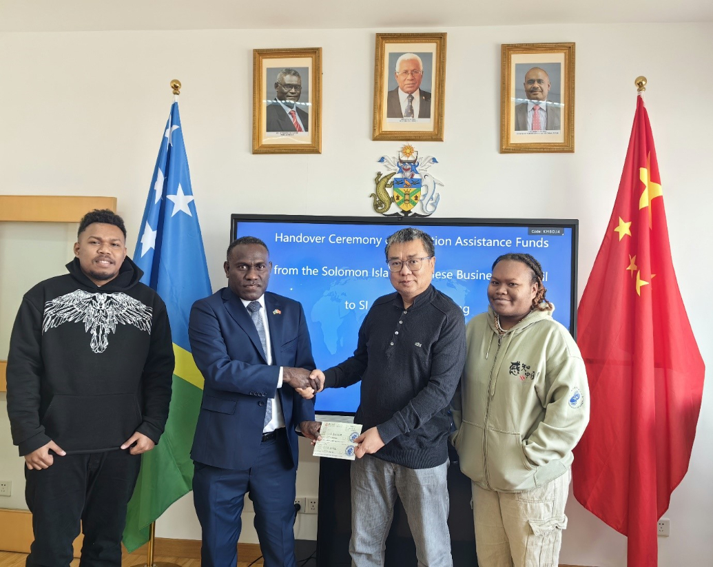 Solomon Islands Ambassador to the Peoples Republic of China, H.E Barrett Salato receiving the assistance from SCBC Representative, Mr. Ze Liu. Looking on is Solomon Islands students, Tony Sutahi and Ms. Kate Gwaena 