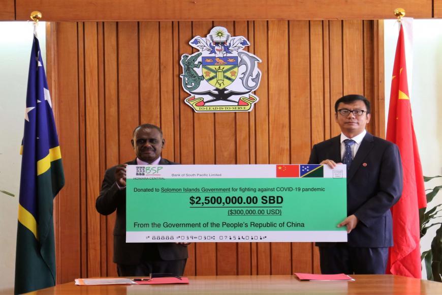 Hon. Manele Receiving the Relief Fund from the PRC Government