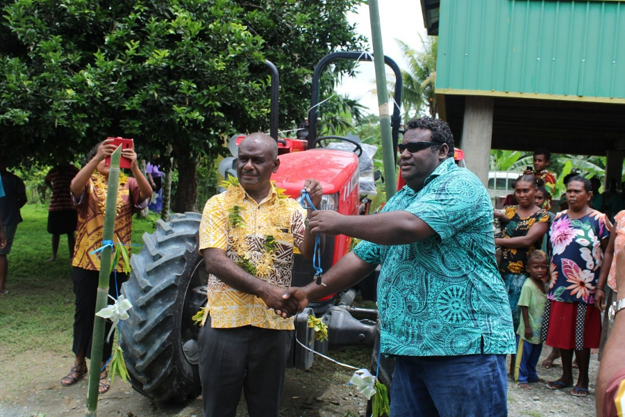 Minister of Foreign Affairs and External Trade, Hon. Jeremiah Manele handing over the key to the new tractor and tiller machine to the chairman of GFA, James Tiva on Friday