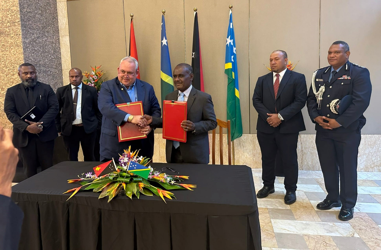 PNG Foreign Affairs Minister Hon. Justin Tkatchenko and SI Foreign Affairs & External Trade Minister, Hon. Jeremiah Manele shake hands after signing of the agreement
